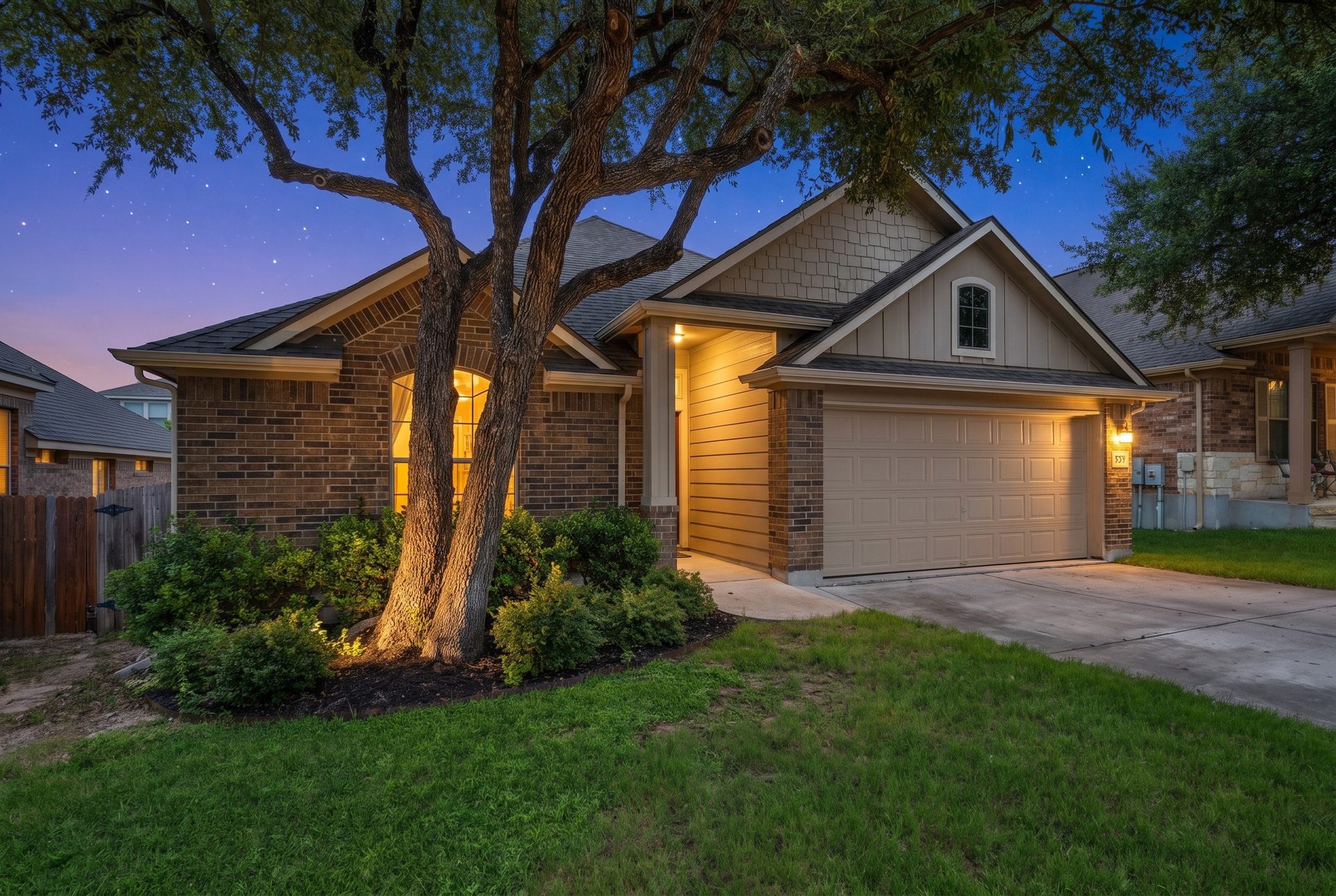 Twilight exterior of a Central Texas home under a pink evening sky