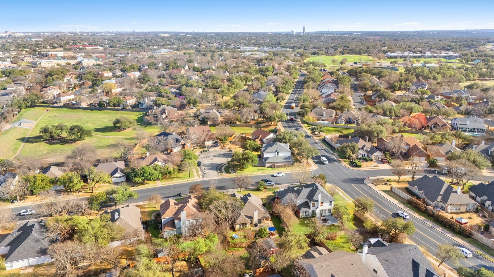 Mature tree-lined street in the Twin Creeks golf community in Cedar Park, Texas